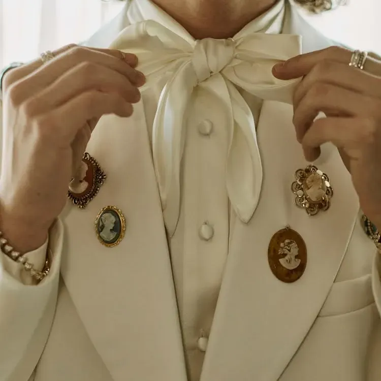 Groom attire with satin bow and cameos on each lapel. Photo by Tanner Fletcher