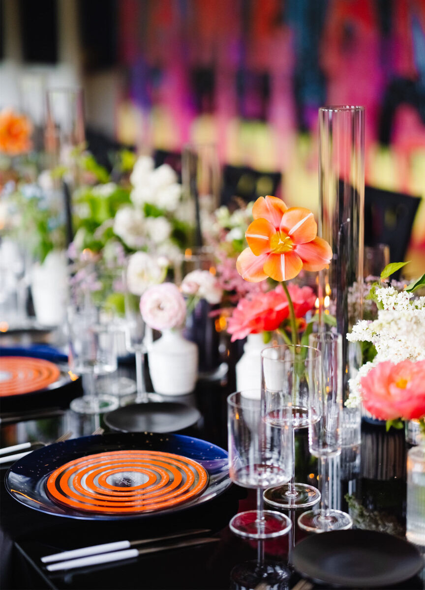 Dark plates, light flatware, and modern stemware made for a unique place setting at this art museum wedding.