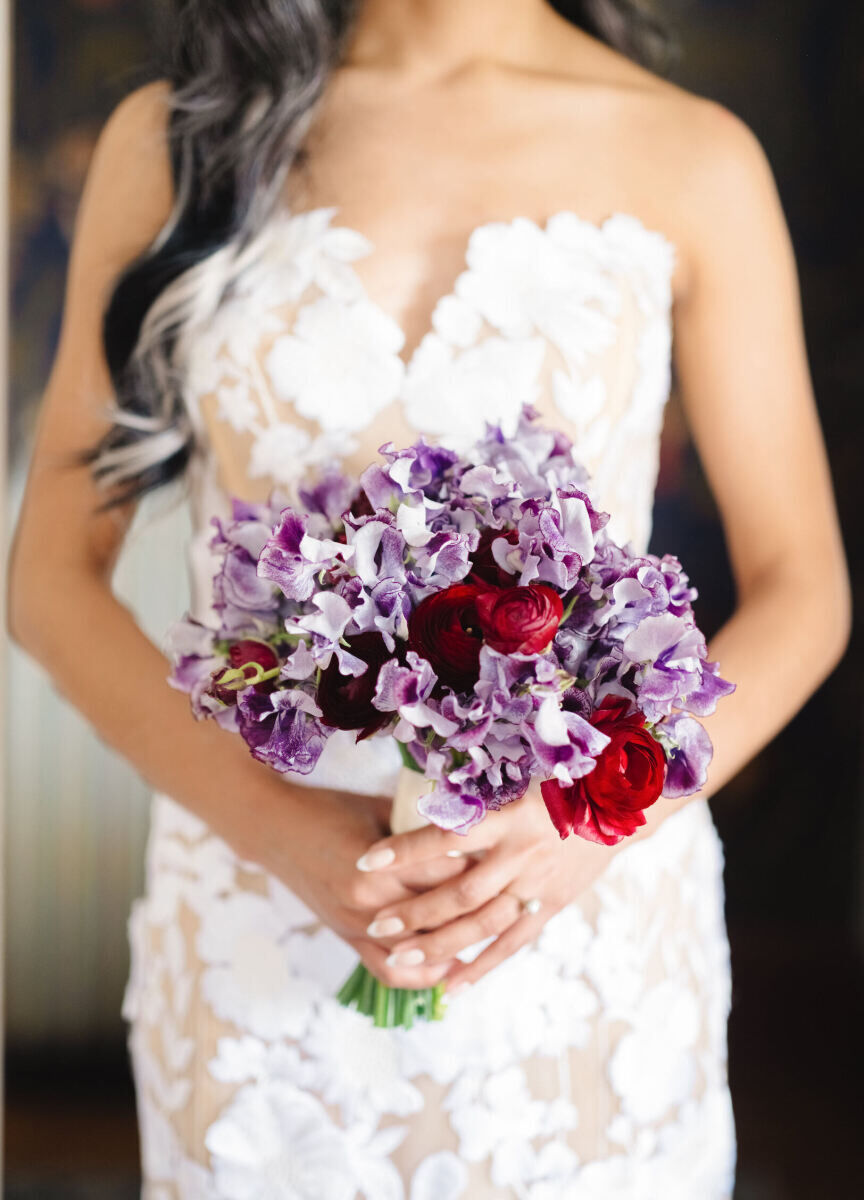 Variagated purple sweet peas and a few red ranunculus made up a colorful bridal bouquet at an art museum wedding.