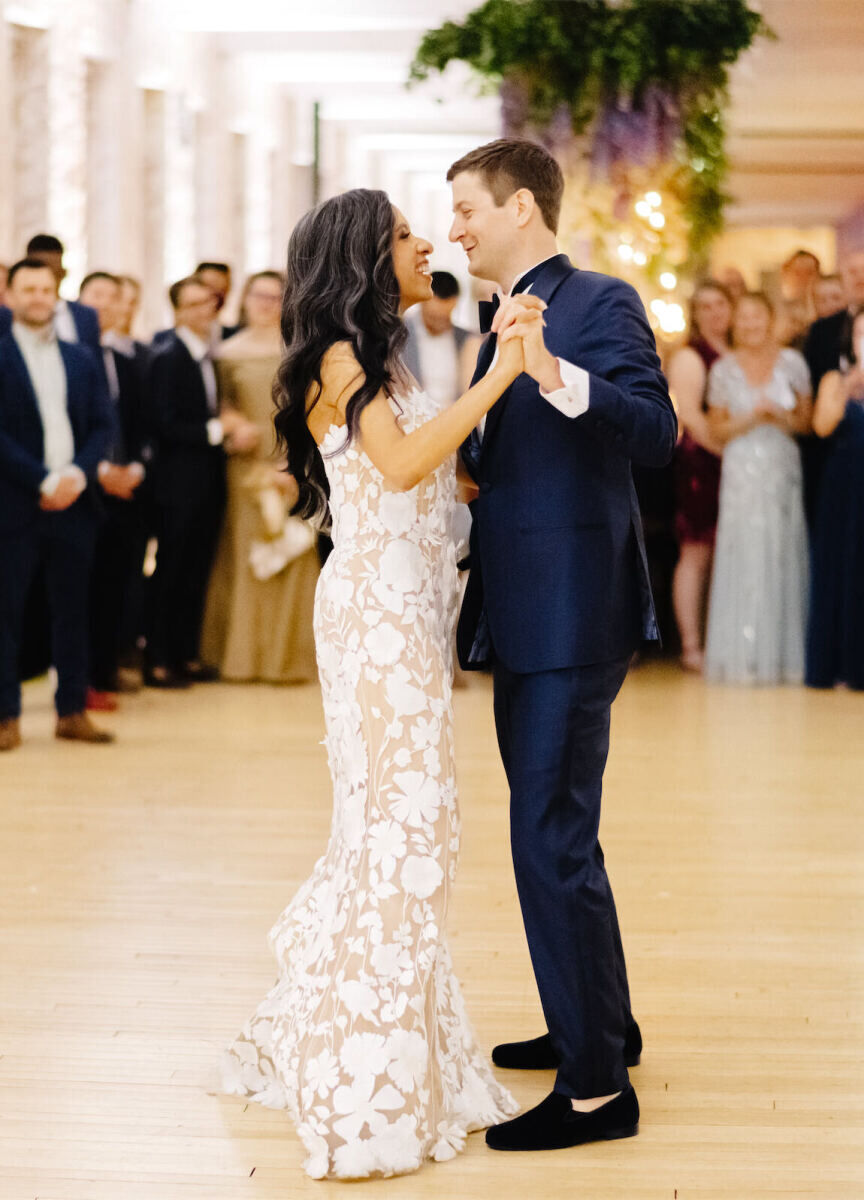 A newlywed couple share a first dance during the reception of their art museum wedding.