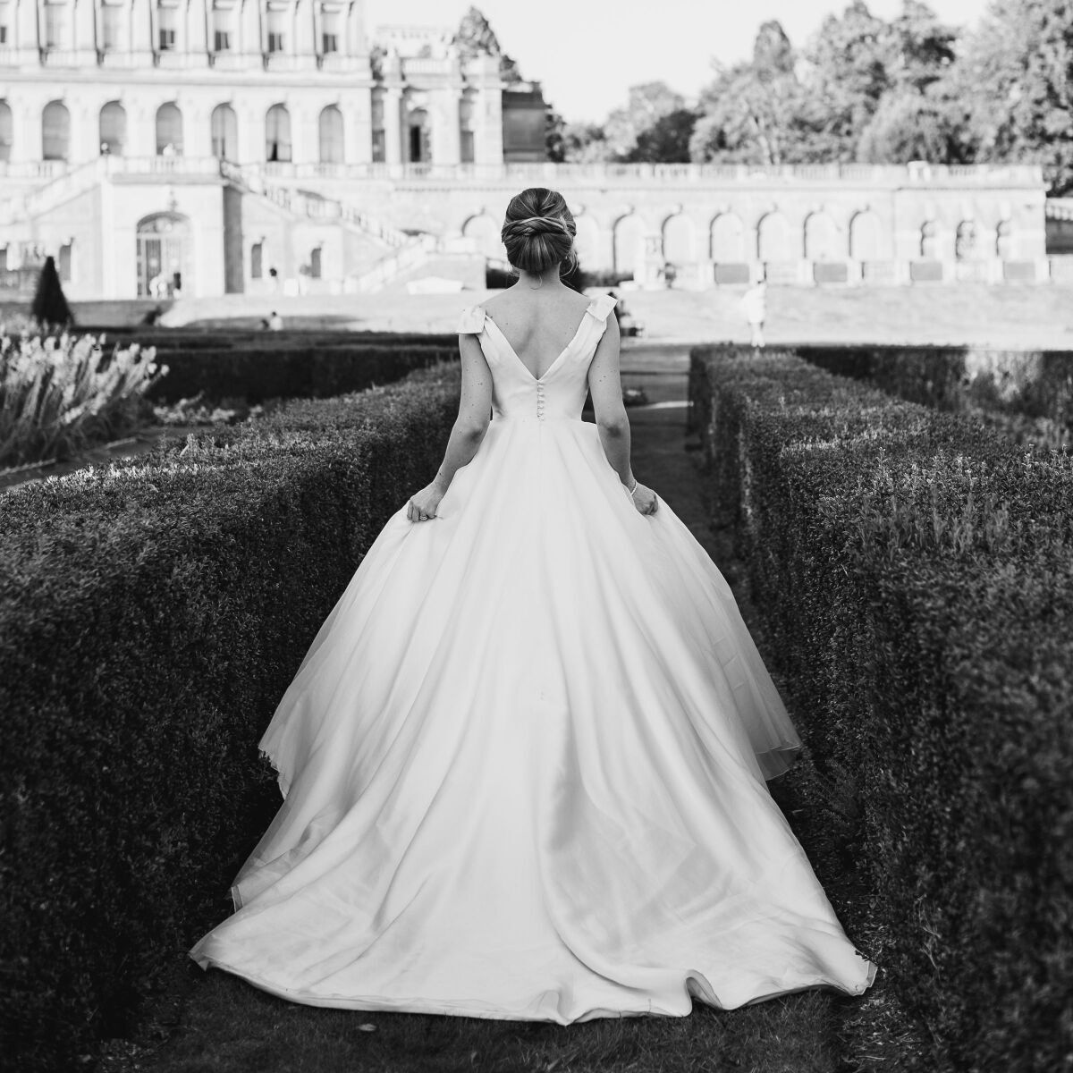 Beautiful white wedding dress on bride walking in garden