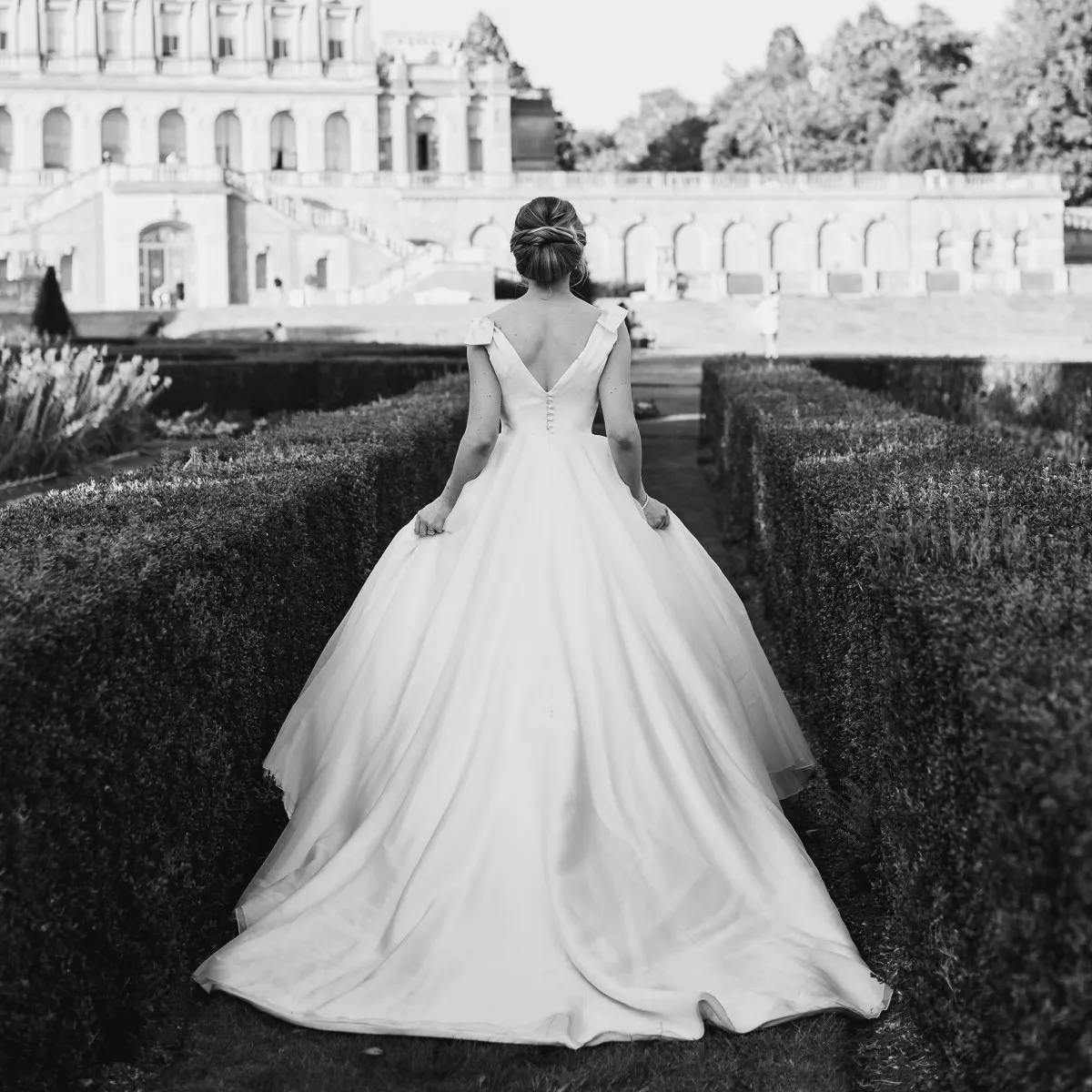 Beautiful white wedding dress on bride walking in garden