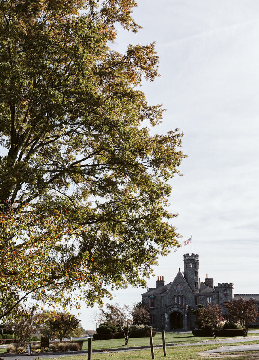 Castle Wedding Venues: A castle wedding venue with a large tree in the foreground, located in Rye, New York.