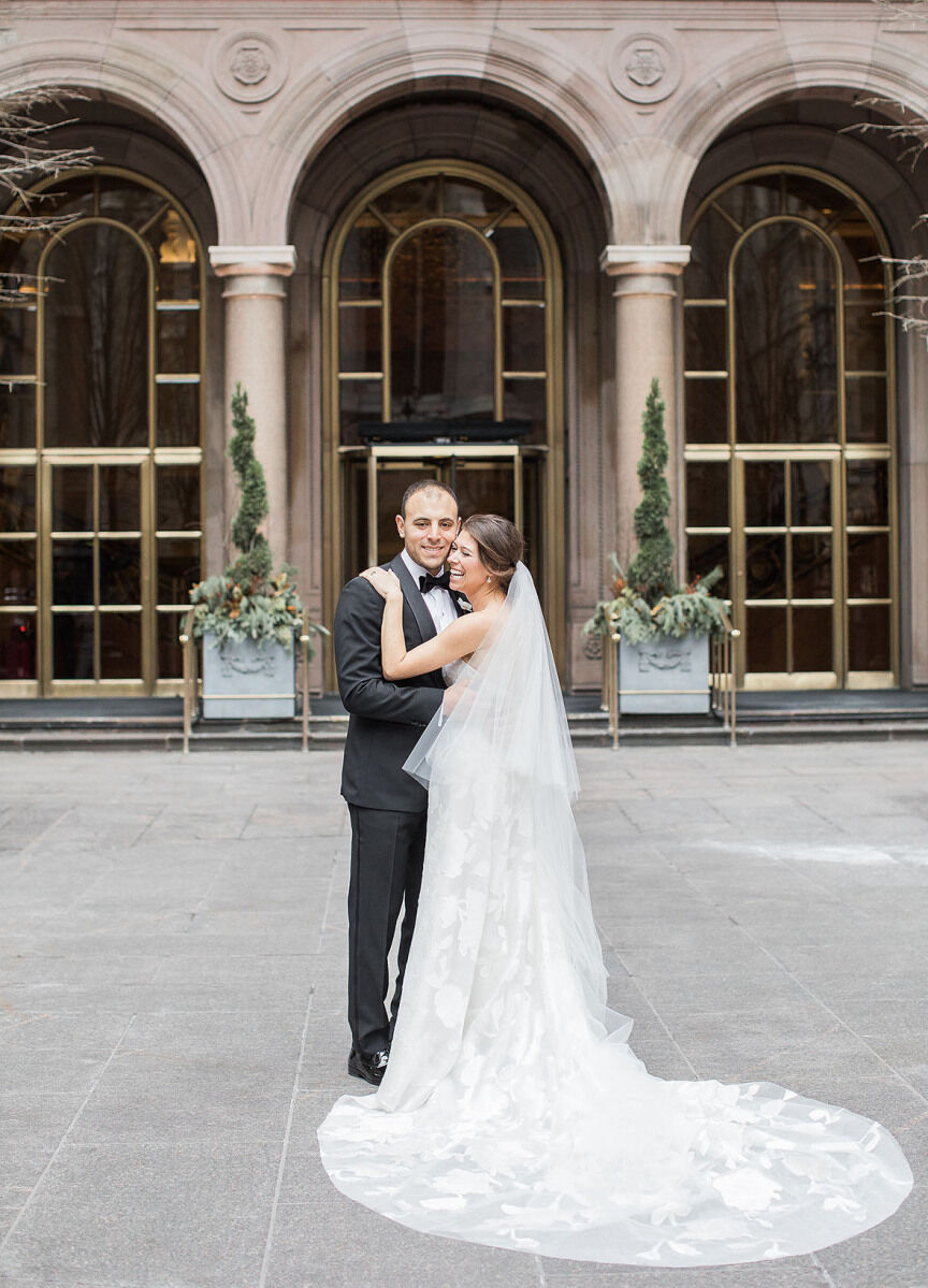 Castle Wedding Venues: A couple smiling during a wedding portrait session in a courtyard at a hotel in New York City.