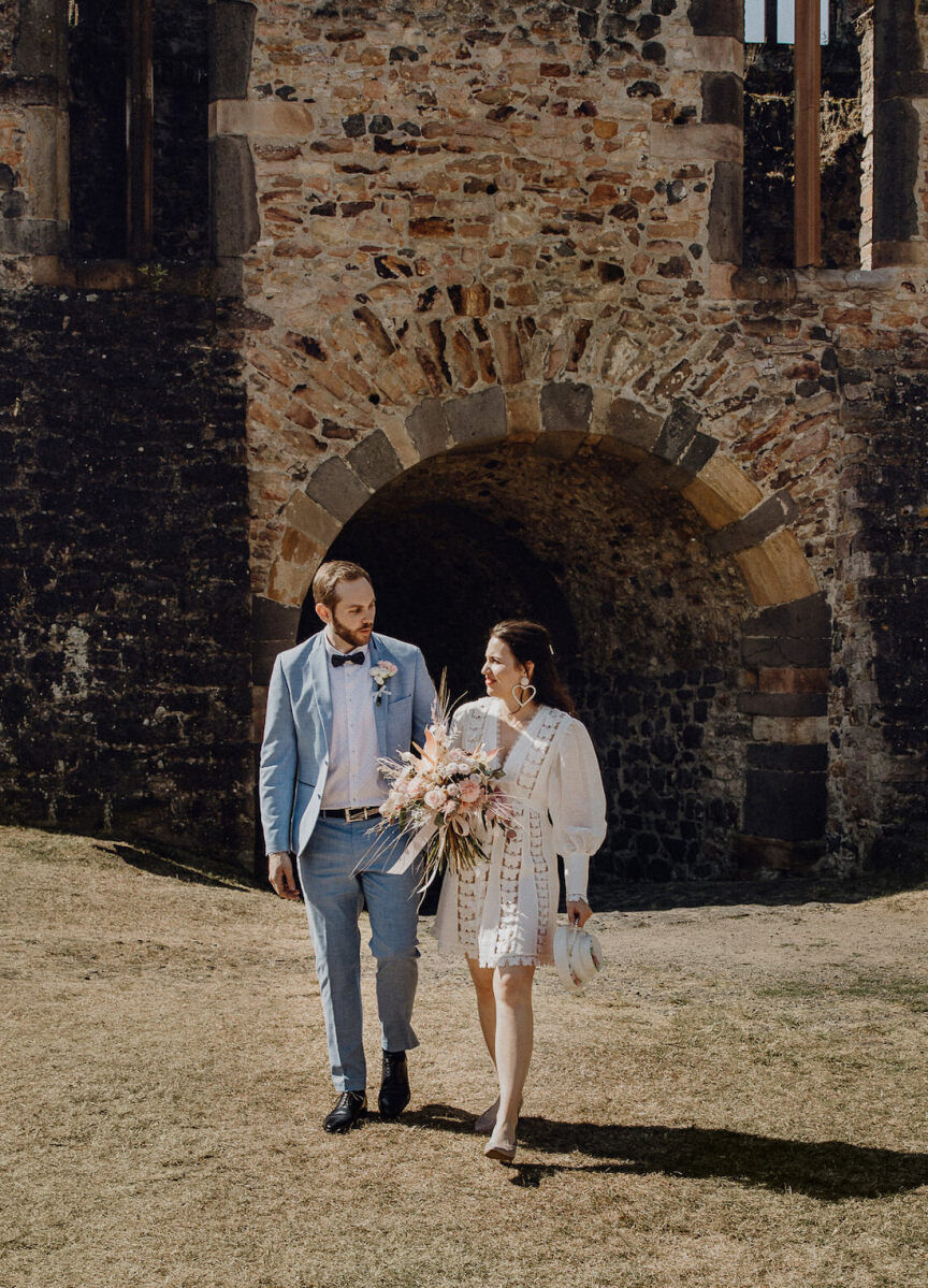 Castle Wedding Venues: A wedding couple in a portrait near the castle ruins of a property in Munzenberg, Germany.