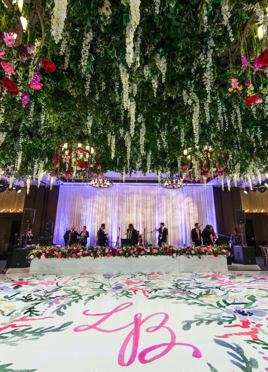 Ceiling Wedding Decor: White and pink flowers hanging above a colorful dance floor.