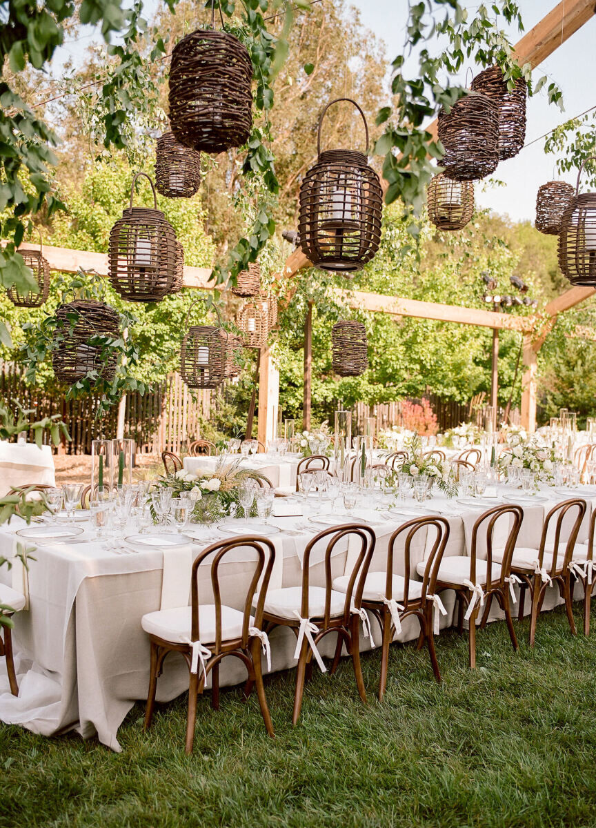 Ceiling Wedding Decor: Dark brown woven light fixtures hanging from the ceiling at an outdoor reception setup.