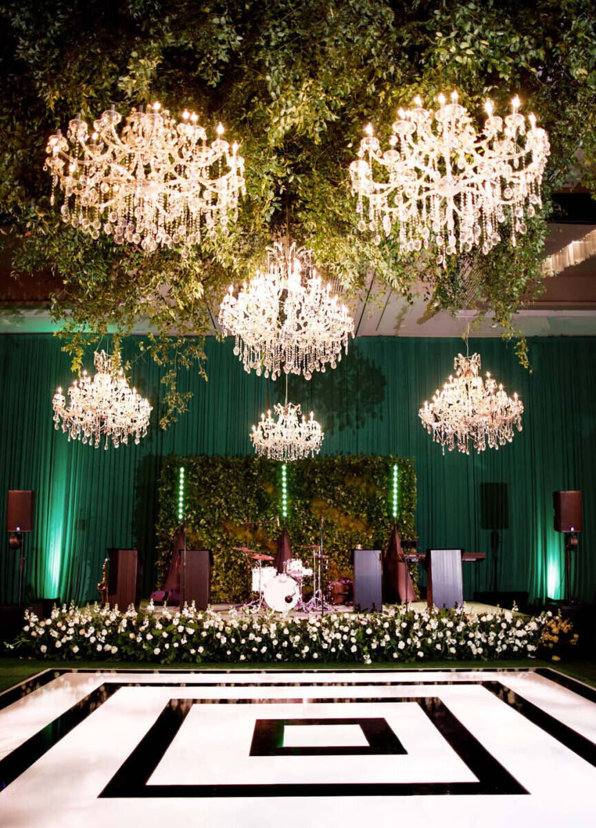 Ceiling Wedding Decor: Six oversize chandeliers hanging above a black and white dance floor.