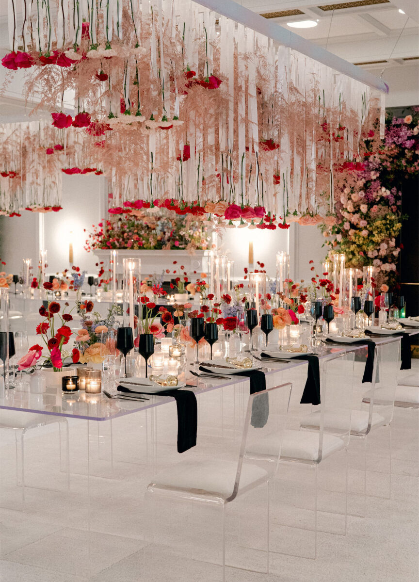 Ceiling Wedding Decor: Rose stems hanging upside down from the ceiling at a rainbow-colored reception.