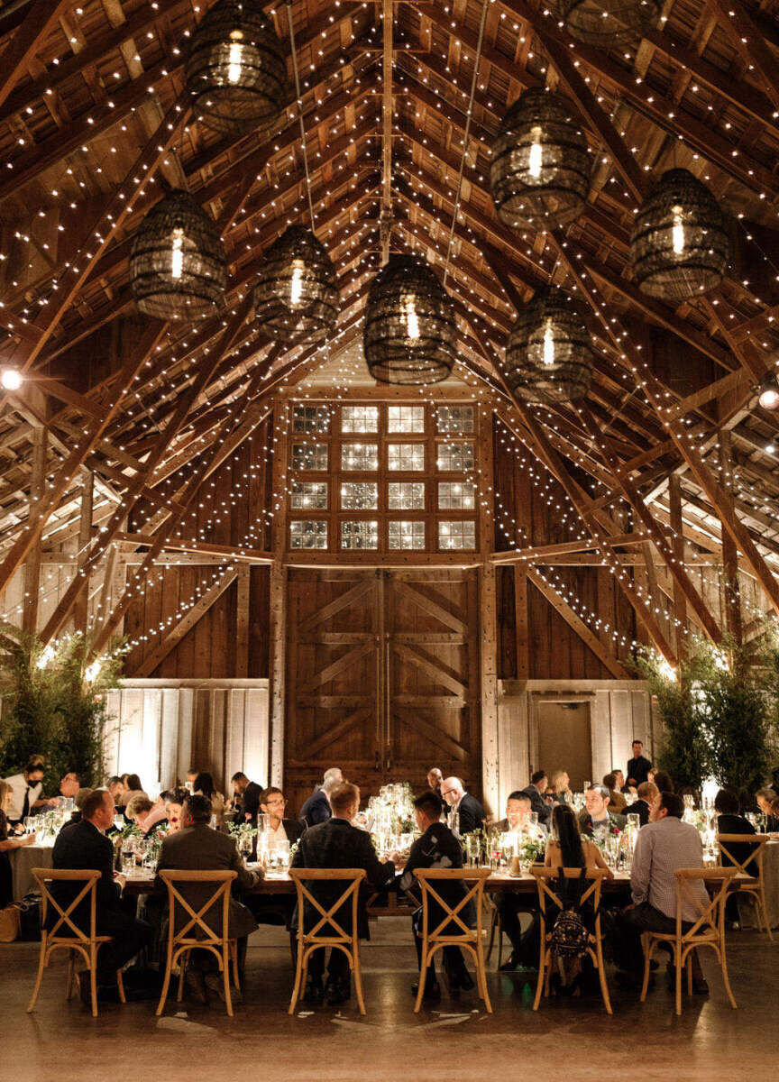 Ceiling Wedding Decor: Woven lanterns and string lights hanging in a lodge-like wedding venue in Northern California.