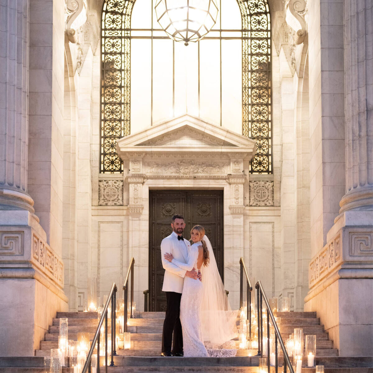 Celebrity Wedding: Kevin Love and Kate Bock posing outside of their wedding venue, The New York Public Library.