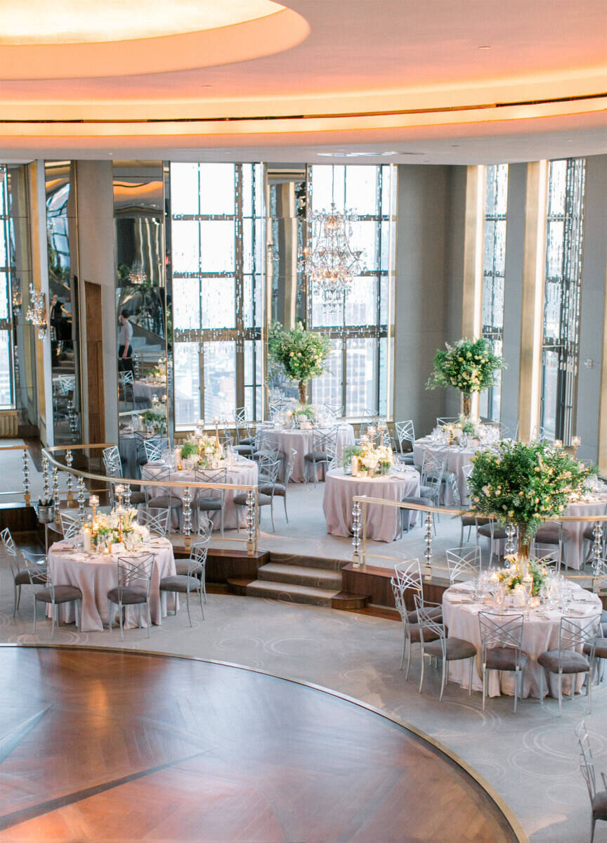 City Weddings: A rotunda-style ballroom wedding venue with round tables and a wooden dance floor.