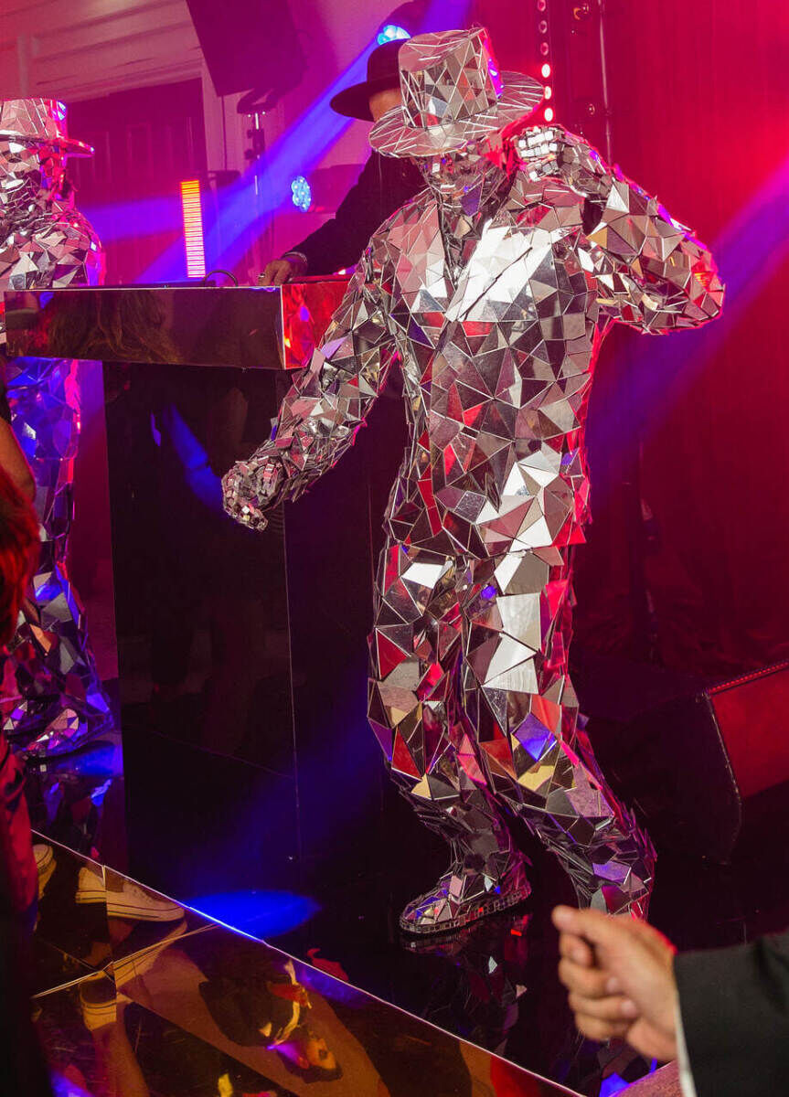 Mirror men perform during a party over the course of a colorful countryside wedding weekend.