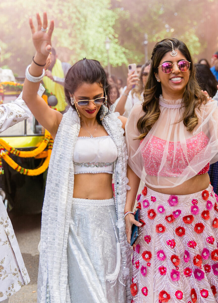 Guests enjoy the baraat during a colorful countryside wedding.