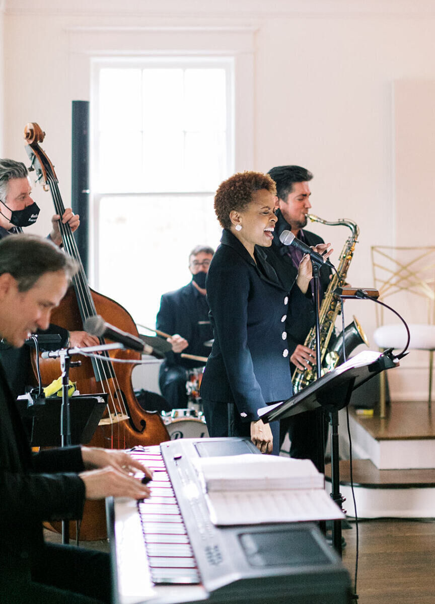 Musicians perform during a multi-course dinner reception.