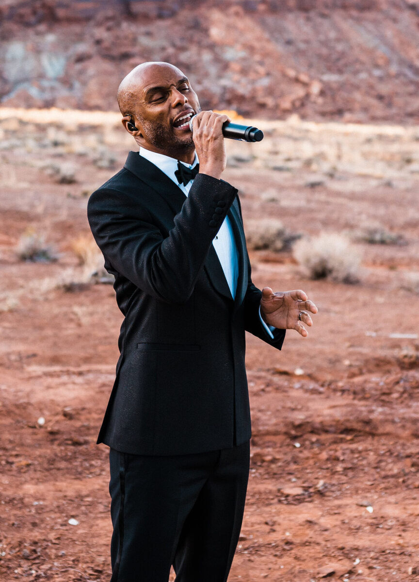 A vocalist performs during a desert wedding at the Red Earth Venue.