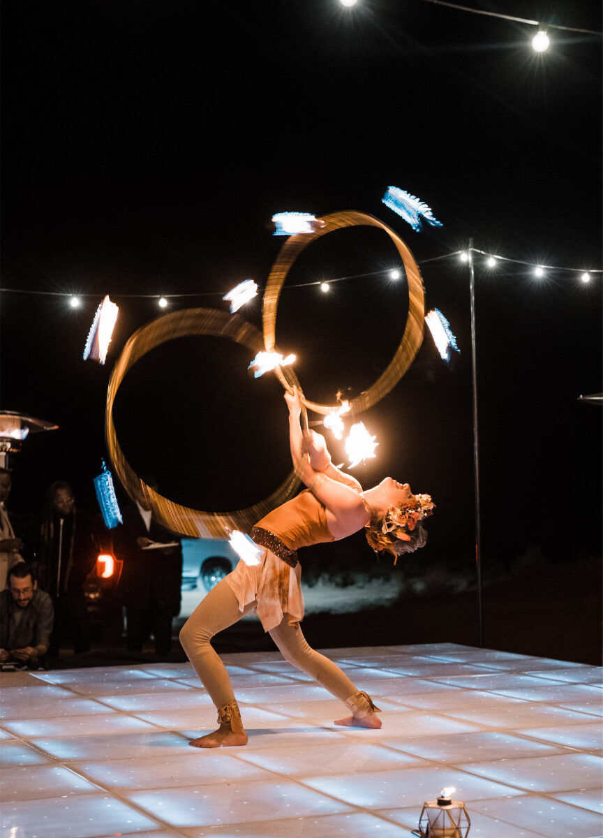 A fire dancer performs during the reception of a desert wedding.