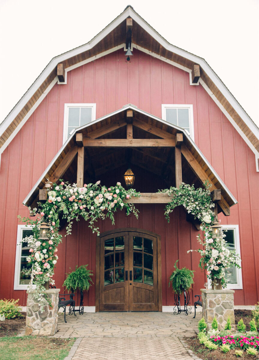 The reception of a destination Indian wedding took place inside a barn in North Carolina that was decorated from the inside out, using pale pink roses and lots of greenery.