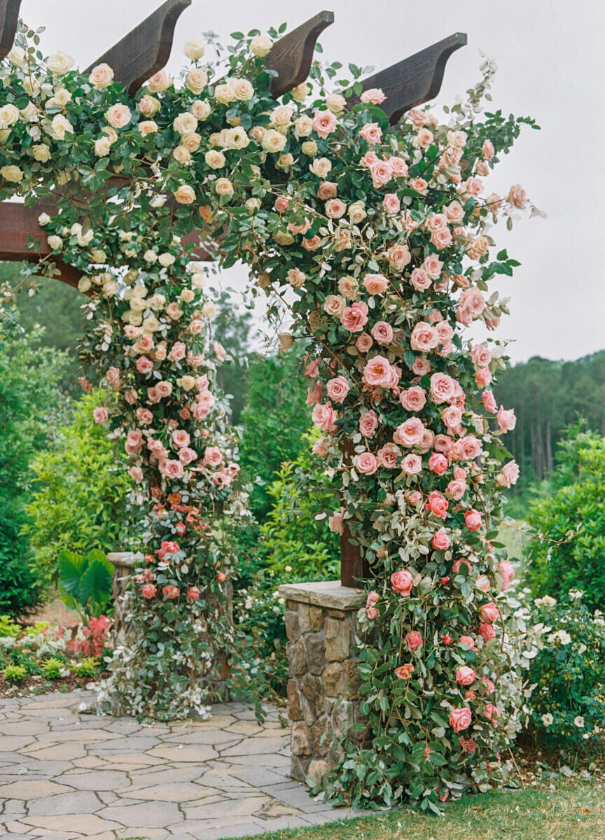 The mandap was covered in an ombre of pink and white flowers for a destination Indian wedding ceremony in North Carolina.