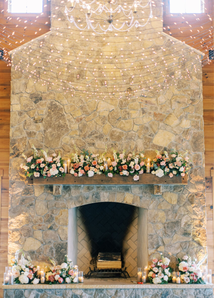 The florist covered the fireplace of the venue where the reception took place during a destination Indian wedding weekend.