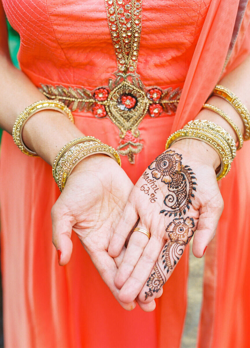 A guest shows off their henna at a destination Indian wedding.