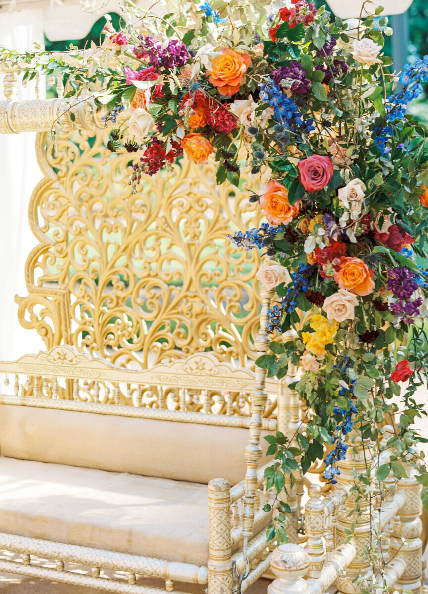 Flowers throughout the weekend-long destination Indian wedding ranged from soft pastels to bold jewel tones, like the ones here that decorated furniture at the sangeet.