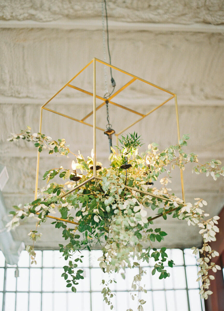 Branches decorated the light fixtures at the welcome dinner during a destination Indian wedding weekend. 