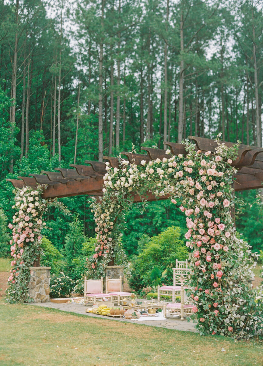 White and pink roses decorated the mandap at the outdoor ceremony of this destination Indian wedding.