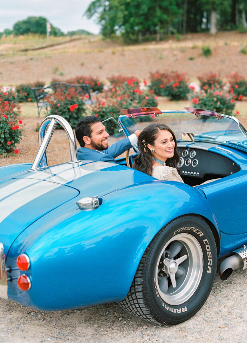 Post-ceremony, the newlyweds arrived to the reception of their destination Indian wedding in a bright blue classic car.