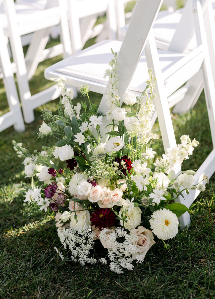 Lush floral arrangements dotted the aisle of an elevated garden wedding.