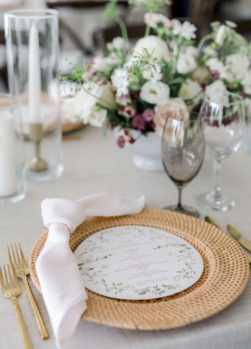 Wicker chargers anchored each place setting of an elevated garden wedding reception in Vermont.