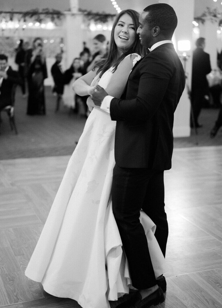 Newlyweds share their first dance during their elevated garden wedding reception.