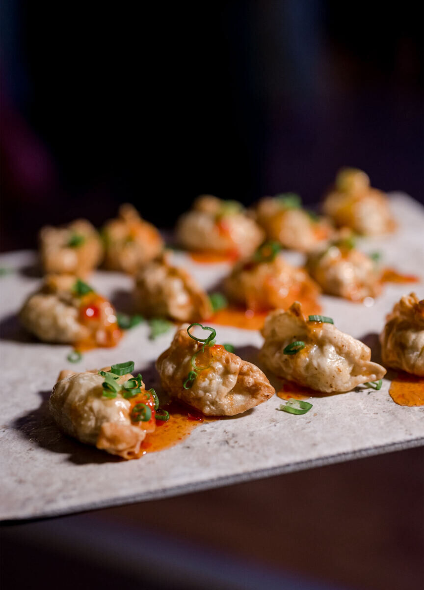 A mix of passed appetizers and late-night small bites made the rounds at an elevated garden wedding. Here, chicken and lemongrass pot stickers.