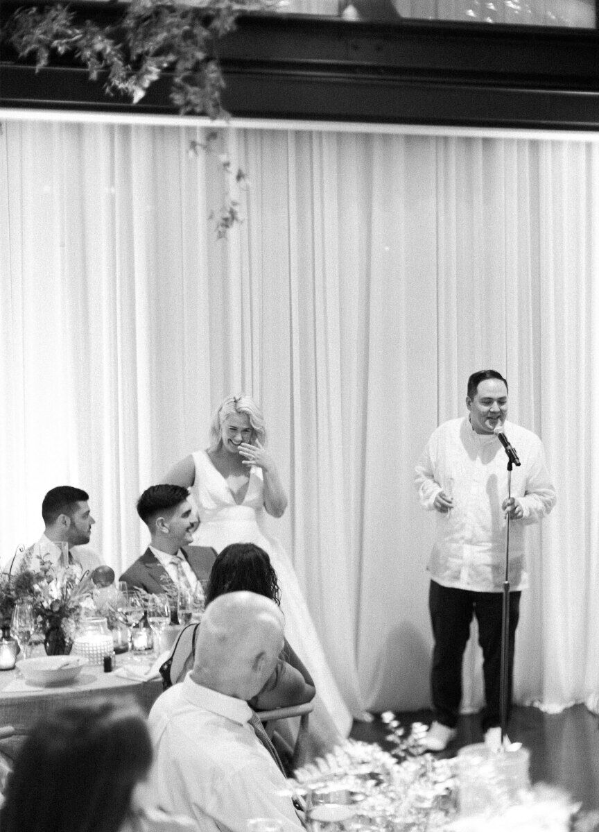 A bride and groom gave a speech at the end of dinner at their enchanted waterfront wedding.