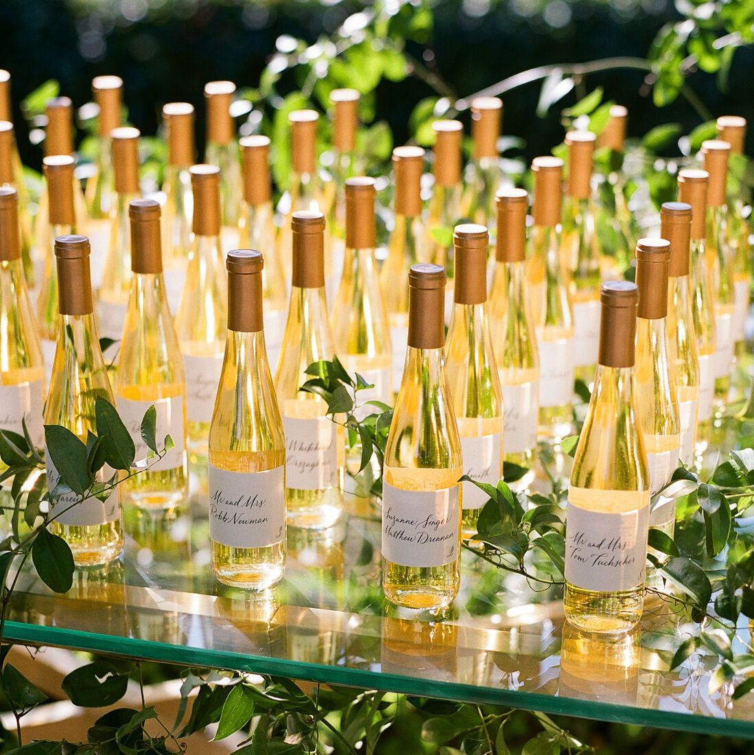 Escort card ideas: Golden wine bottle wedding escort card table