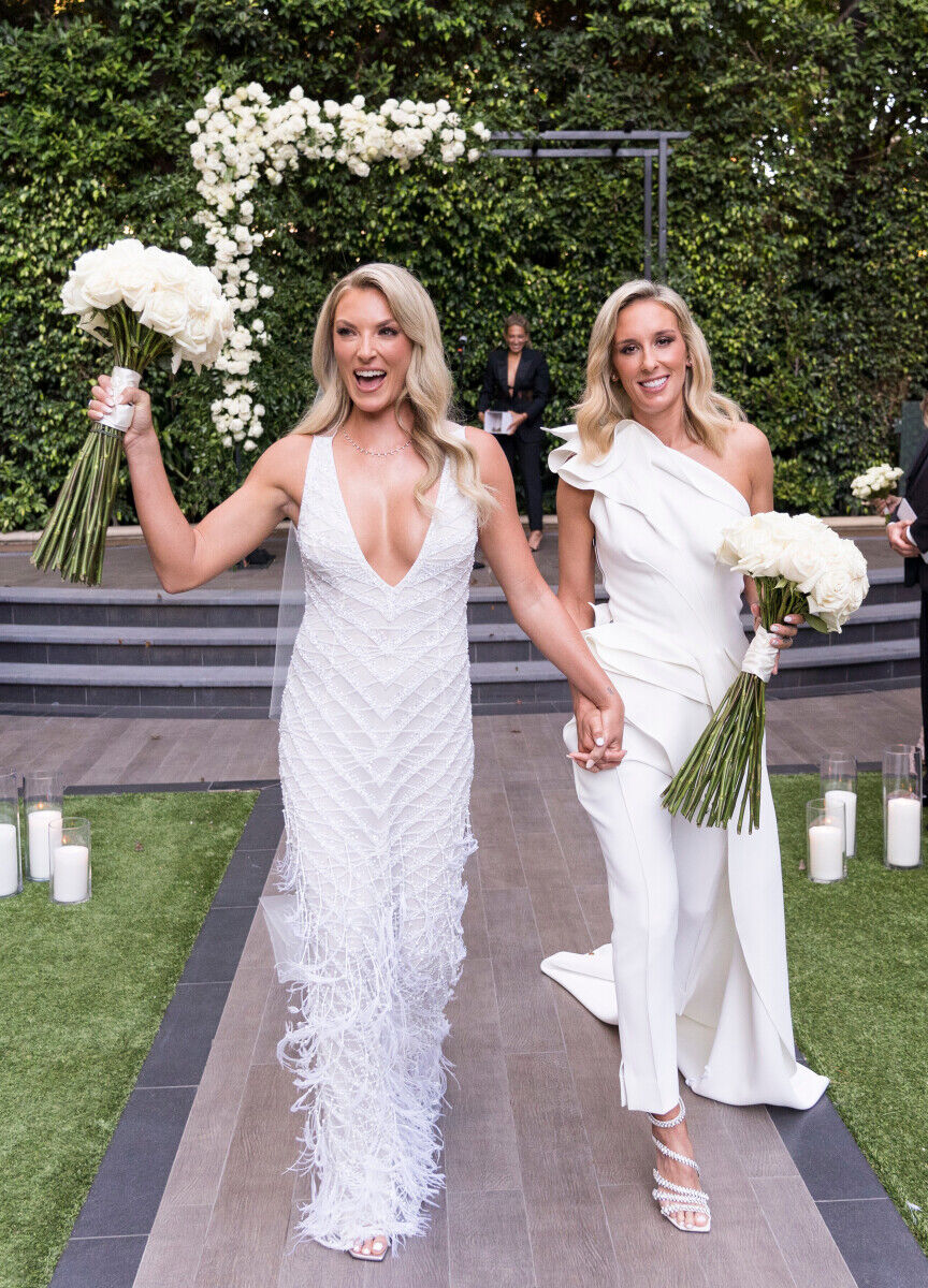 Wedding couple walking up the aisle hand in hand after just saying their I-DOs.