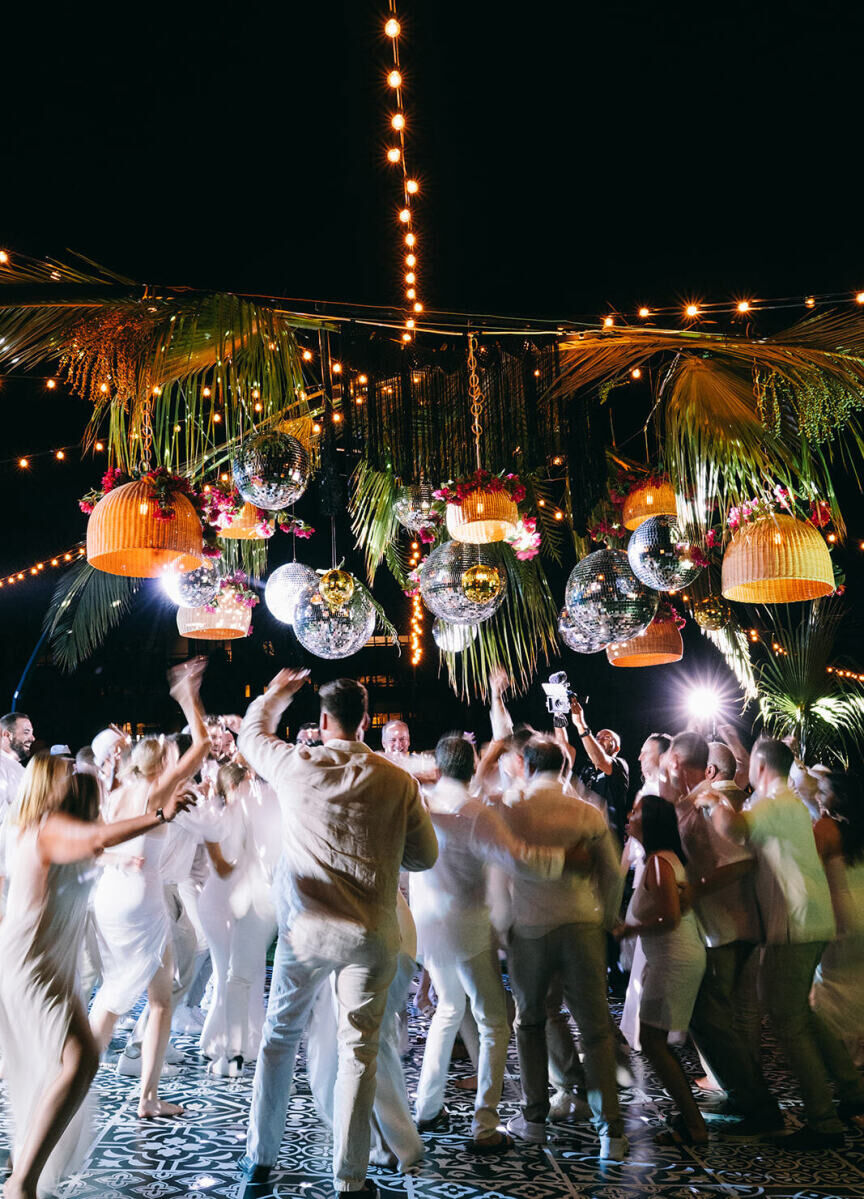 Everyone danced all night at this glam beach wedding, which had disco balls over the dancefloor.