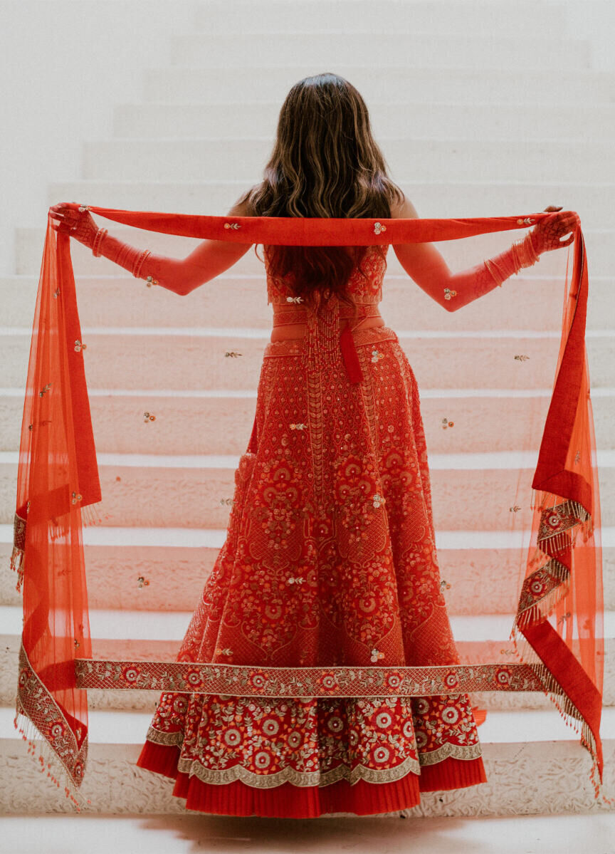 Grand Velas Riviera Nayarit: A bride with her back turned at the foot of a tall white staircase.