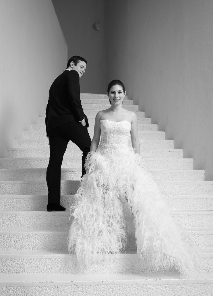 Grand Velas Riviera Nayarit: A bride and groom standing on a tall white staircase.