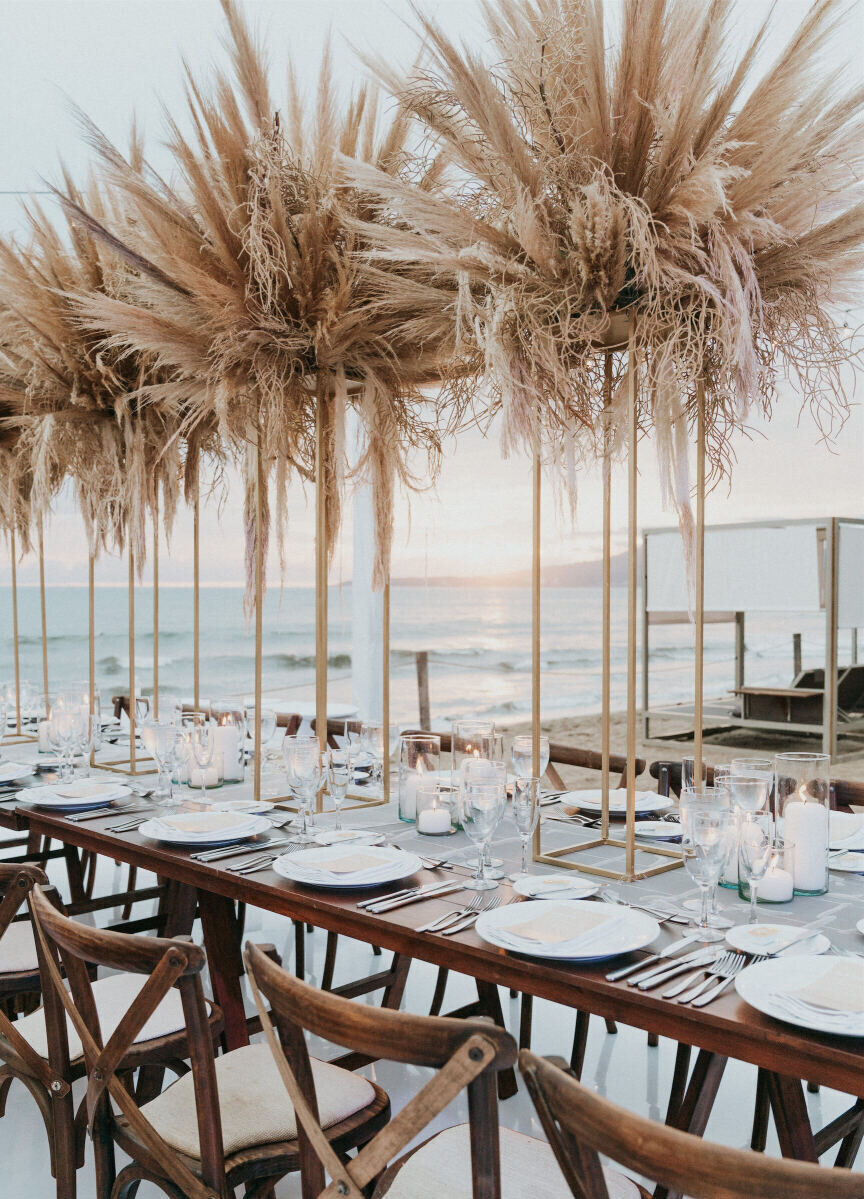 Grand Velas Riviera Nayarit: Elaborate pampas grass arrangements on reception tables at a wedding.