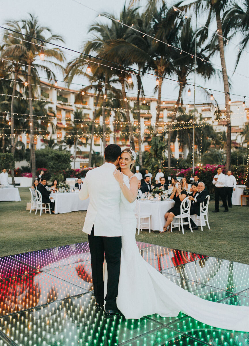 Grand Velas Riviera Nayarit: A bride and groom dance on top of a dance floor lit up with every color of the rainbow.