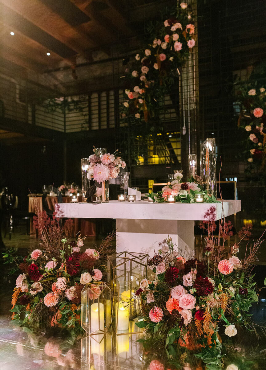 The head table at this industrial wedding was meant to look like it was made from concrete, and surrounded by candles and flowers.