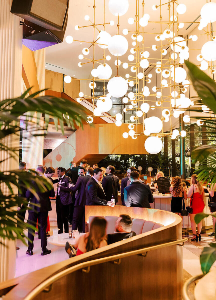 Industrial Wedding Venues: A hanging light installation hanging above wedding guests at C. Baldwin.