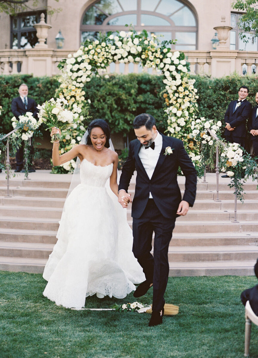 Jump the Broom: Wedding couple participating in the jumping the broom wedding tradition