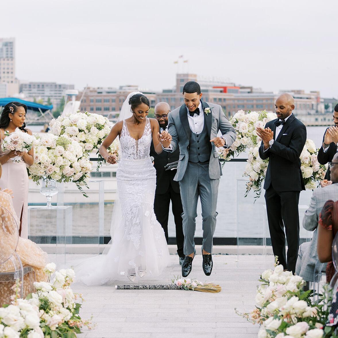 Jump the Broom: Wedding couple participating in the jumping the broom wedding tradition