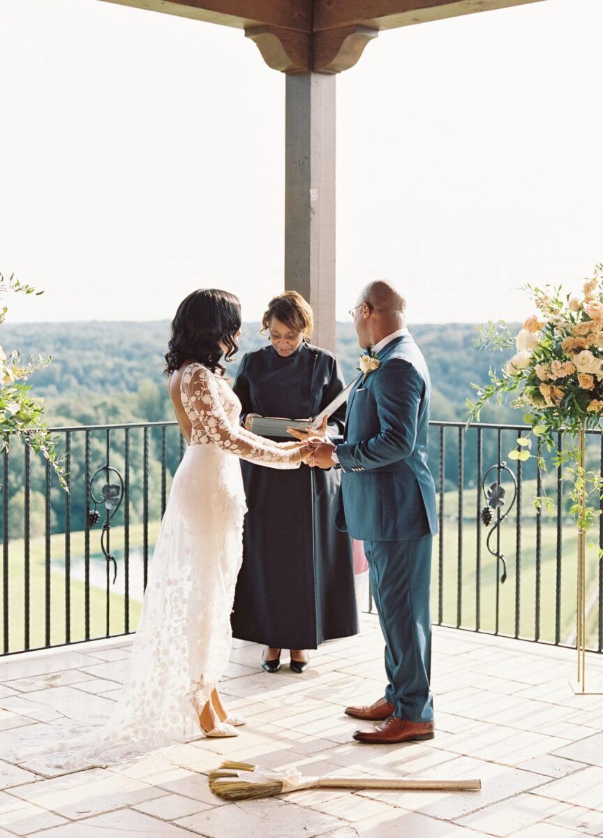 Jump the Broom: Wedding couple participating in the jumping the broom wedding tradition