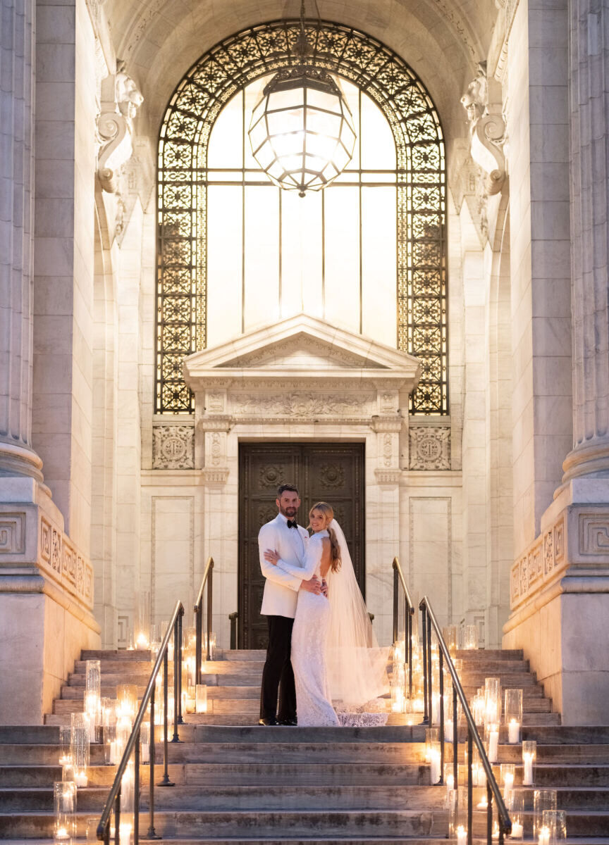 Kate Bock Kevin Love Wedding: Kevin Love and Kate Bock posing on a candle-lined staircase on their wedding night.