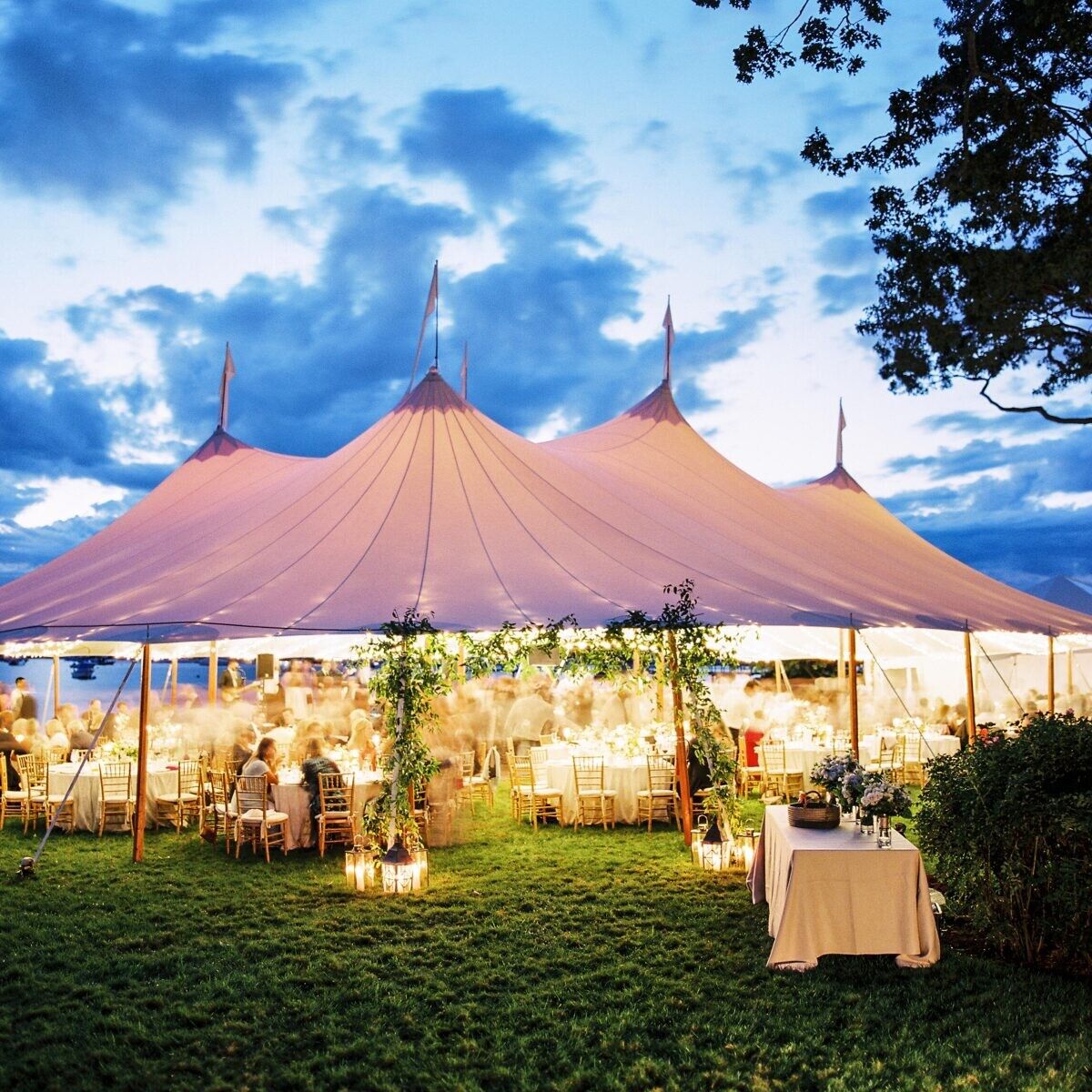 Wedding budget: Glowy tented wedding reception at dusk