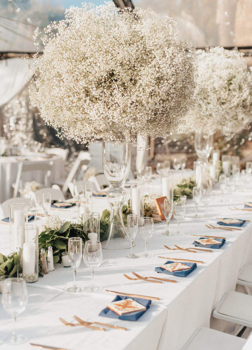 Marriott Weddings: A reception table setup with oversized installations of baby's breath hanging over the long table.