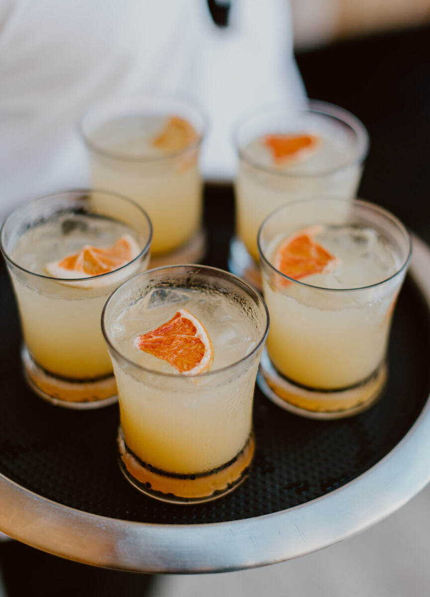 Citrusy cocktails being served at a Mexican wedding.